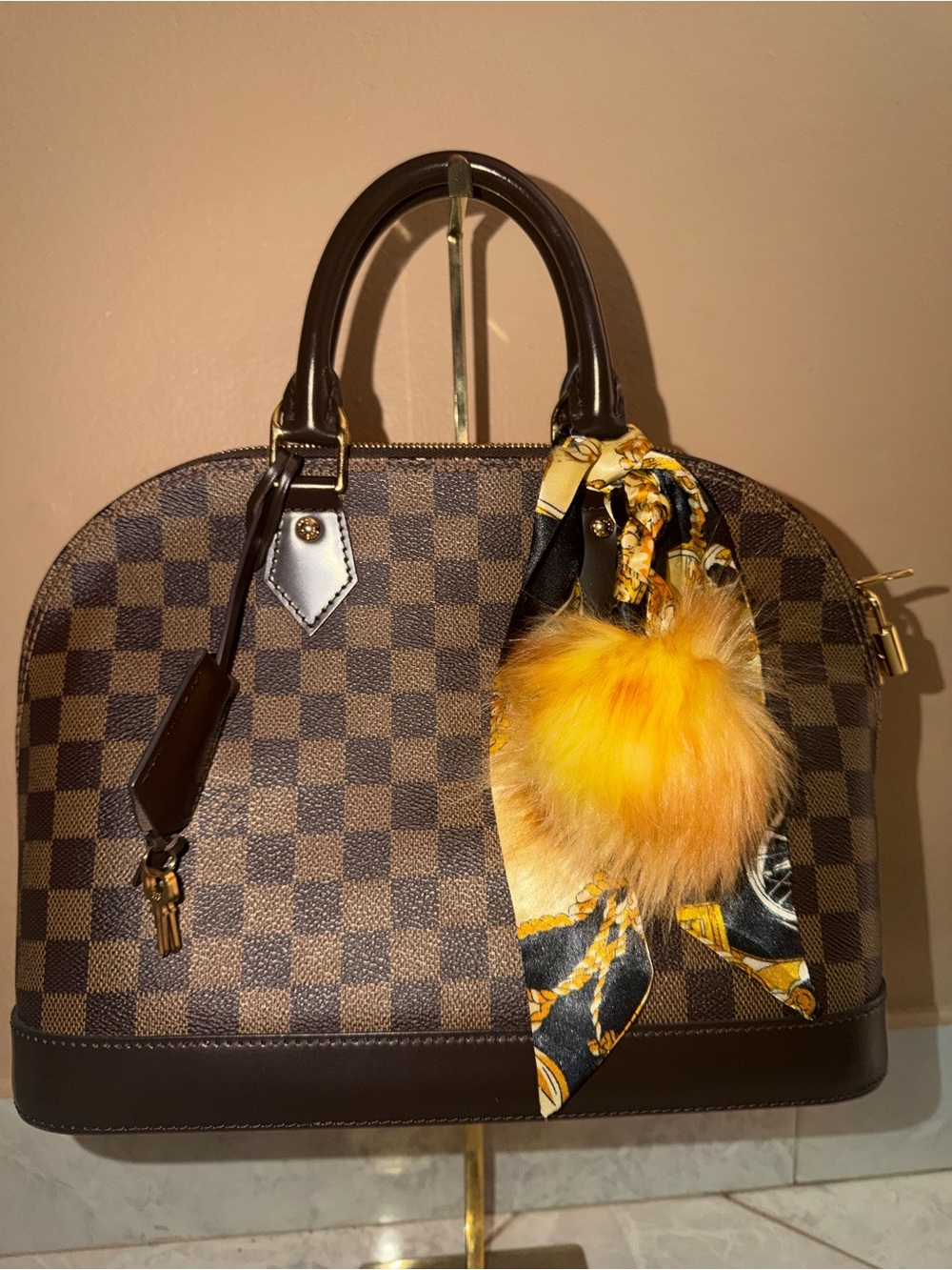 Louis Vuitton Damier Ebene Alma PM
Brown Top Handle Zip Bag w/ Lock and keys.